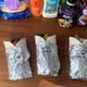 Three assembled imitation McWraps in foil on the kitchen table